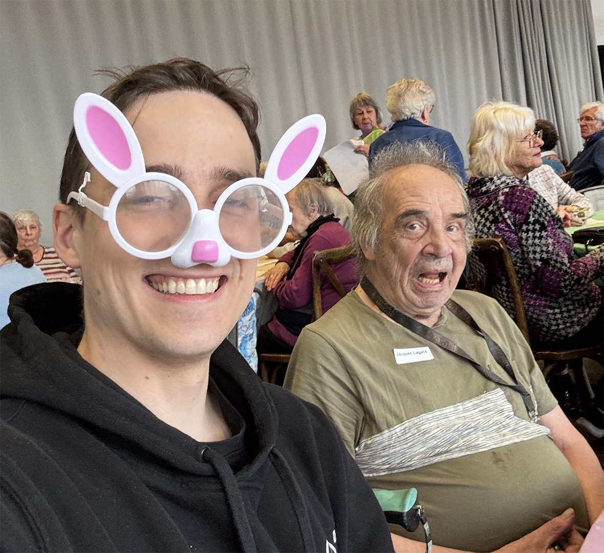 Tony Aubé volunteering with a senior at a community event.