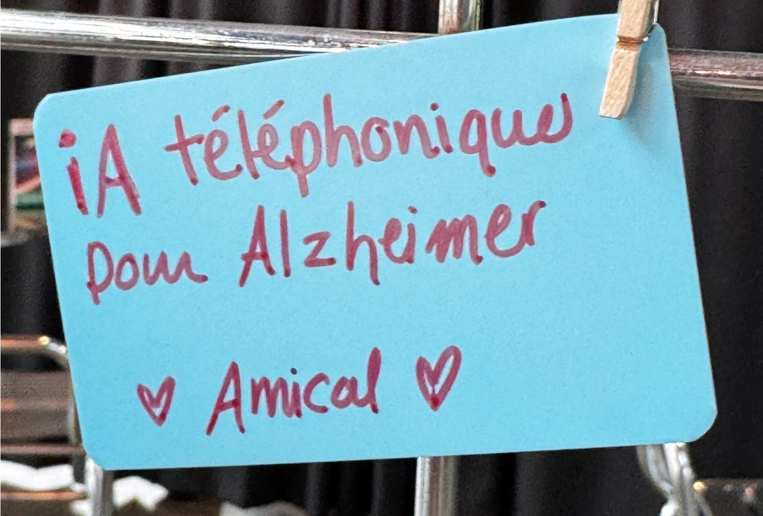 Handwritten note on a blue card: phone AI for Alzheimer's, with hearts and the word Amical